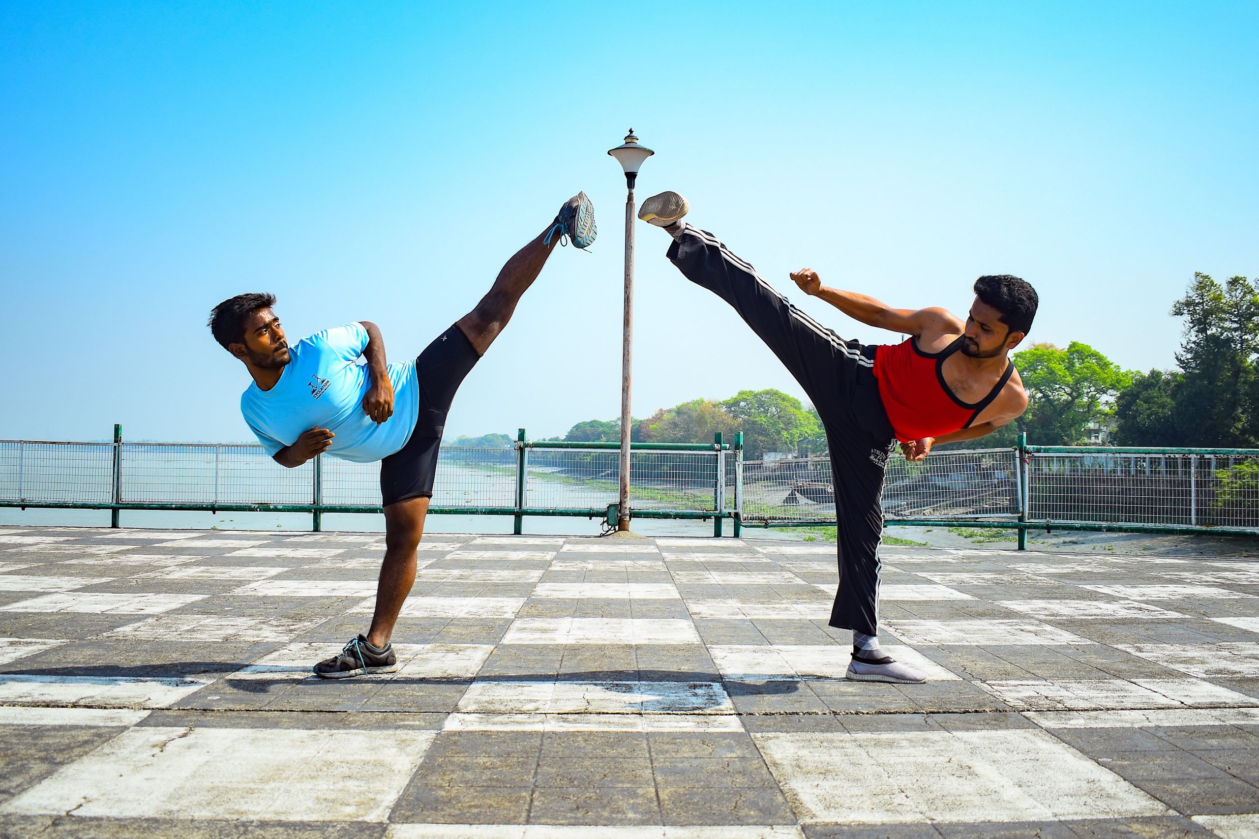 Image of two people kicking the air.